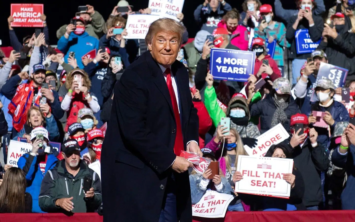 TOPSHOT - US President Donald Trump throws masks as he arrives to hold a Make America Great Again rally as he campaigns at John Murtha Johnstown-Cambria County Airport in Johnstown, Pennsylvania, October 13, 2020. (Photo by SAUL LOEB / AFP)