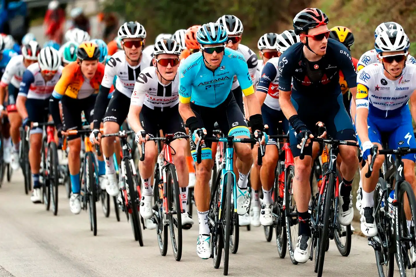 Team Astana rider Denmark's Jakob Diemer Fuglsang (C), wearing the blue jersey, rides with the peloton during the 10th stage of the Giro d'Italia 2020 cycling race, a 177-kilometer route between Lanciano and Tortoreto, on October 13, 2020. (Photo by Luca Bettini / AFP)