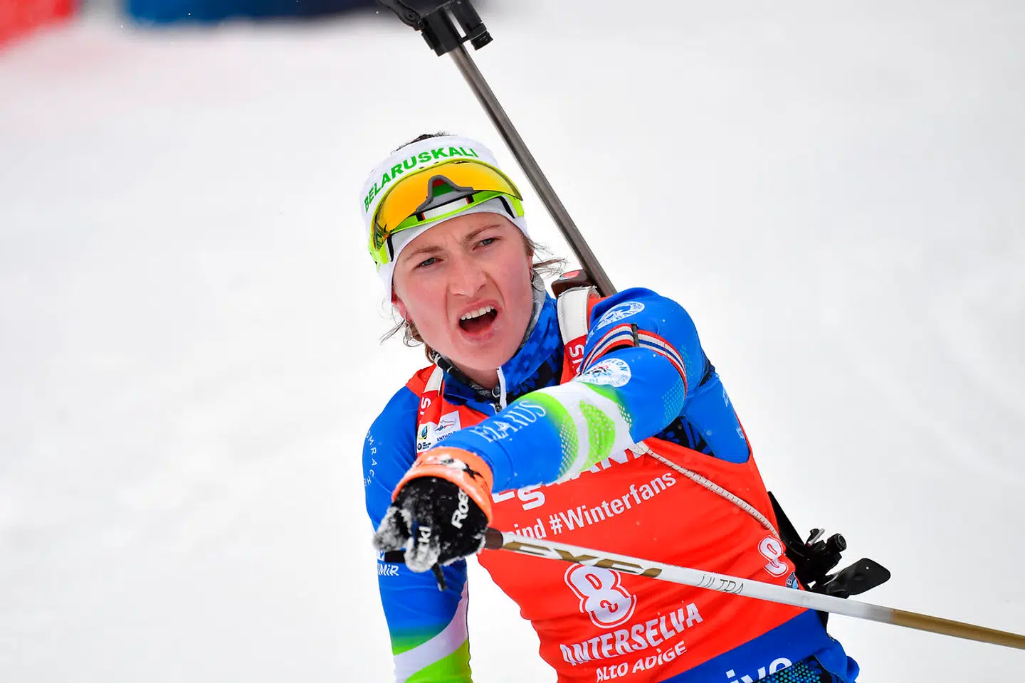 Darya Domracheva of Belarus celebrates as she crosses the finish line to win the Women's 12.5 km Mass Start Competition of the IBU World Cup Biathlon in Anterselva (Antholz) on January 21, 2018. Alberto PIZZOLI / AFP