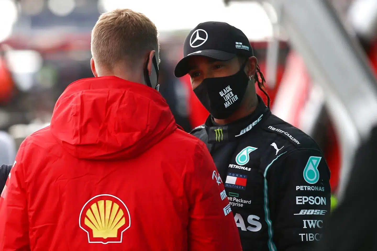 Alfa Romeo's German driver Mick Schumacher (L) talks to winner Mercedes' British driver Lewis Hamilton after the German Formula One Eifel Grand Prix at the Nuerburgring circuit in Nuerburg, western Germany, on October 11, 2020. (Photo by Bryn Lennon / POOL / AFP)