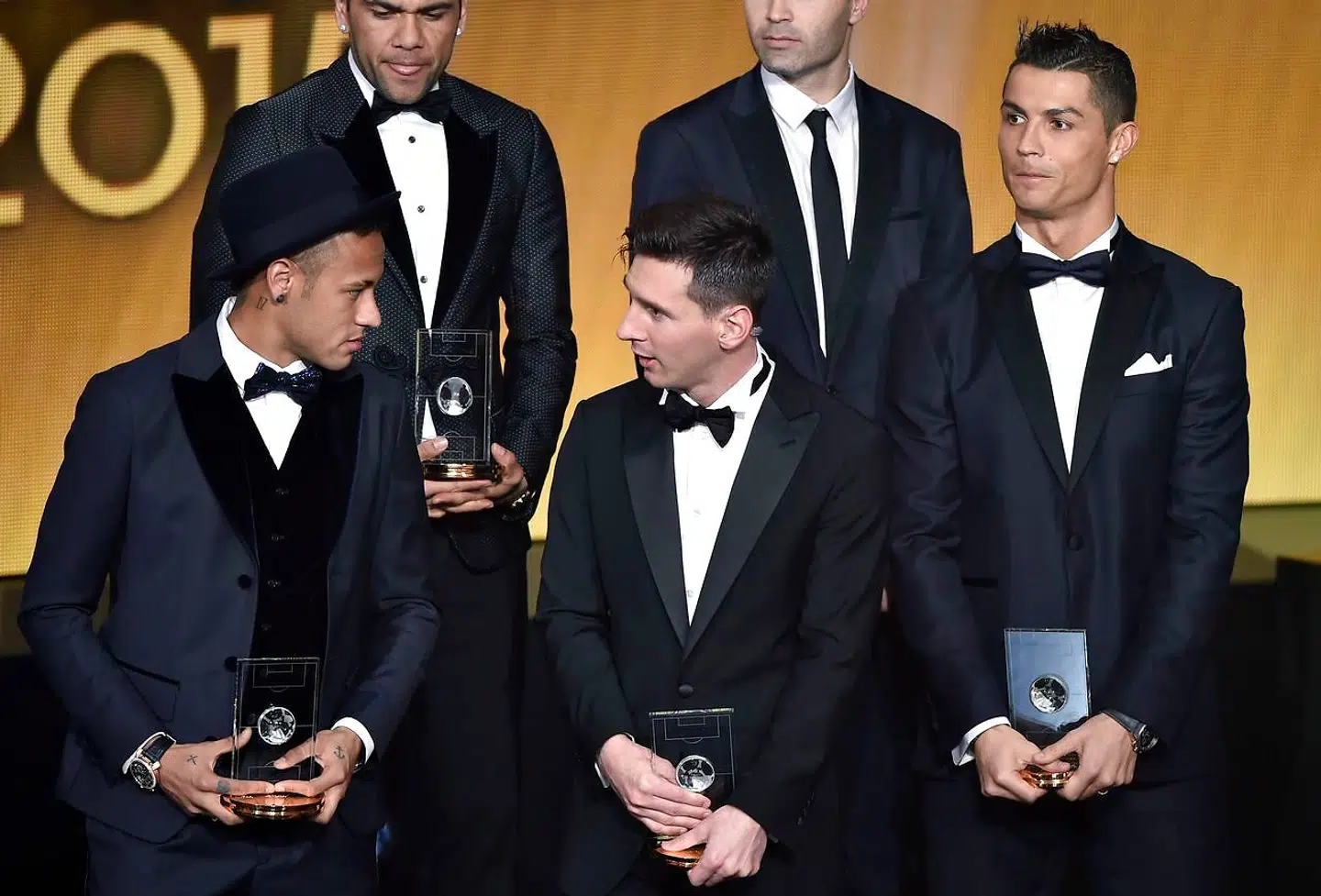 (From L) Brazil and FC Barcelona forward Neymar, Brazil and FC Barcelona defender Dani Alves, Argentina and FC Barcelona forward Lionel Messi, and Portugal and Real Madrid forward Cristiano Ronaldo pose on stage after being selected in the 2015 FIFA FIFPro World XI during the 2015 FIFA Ballon d'Or award ceremony at the Kongresshaus in Zurich on January 11, 2016. AFP PHOTO FABRICE COFFRINI