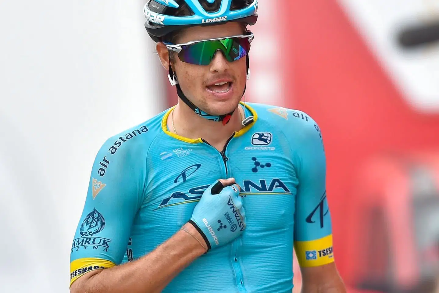 TOPSHOT - Team Astana rider Denmark's Jakob Diemer Fuglsang gestures as he crosses the finish line of the 16th stage of the 2019 La Vuelta cycling Tour of Spain, a 144, 4 km race from Pravia to the Alto de la Cubilla in Lena on September 9, 2019. (Photo by Ander GILLENEA / AFP)