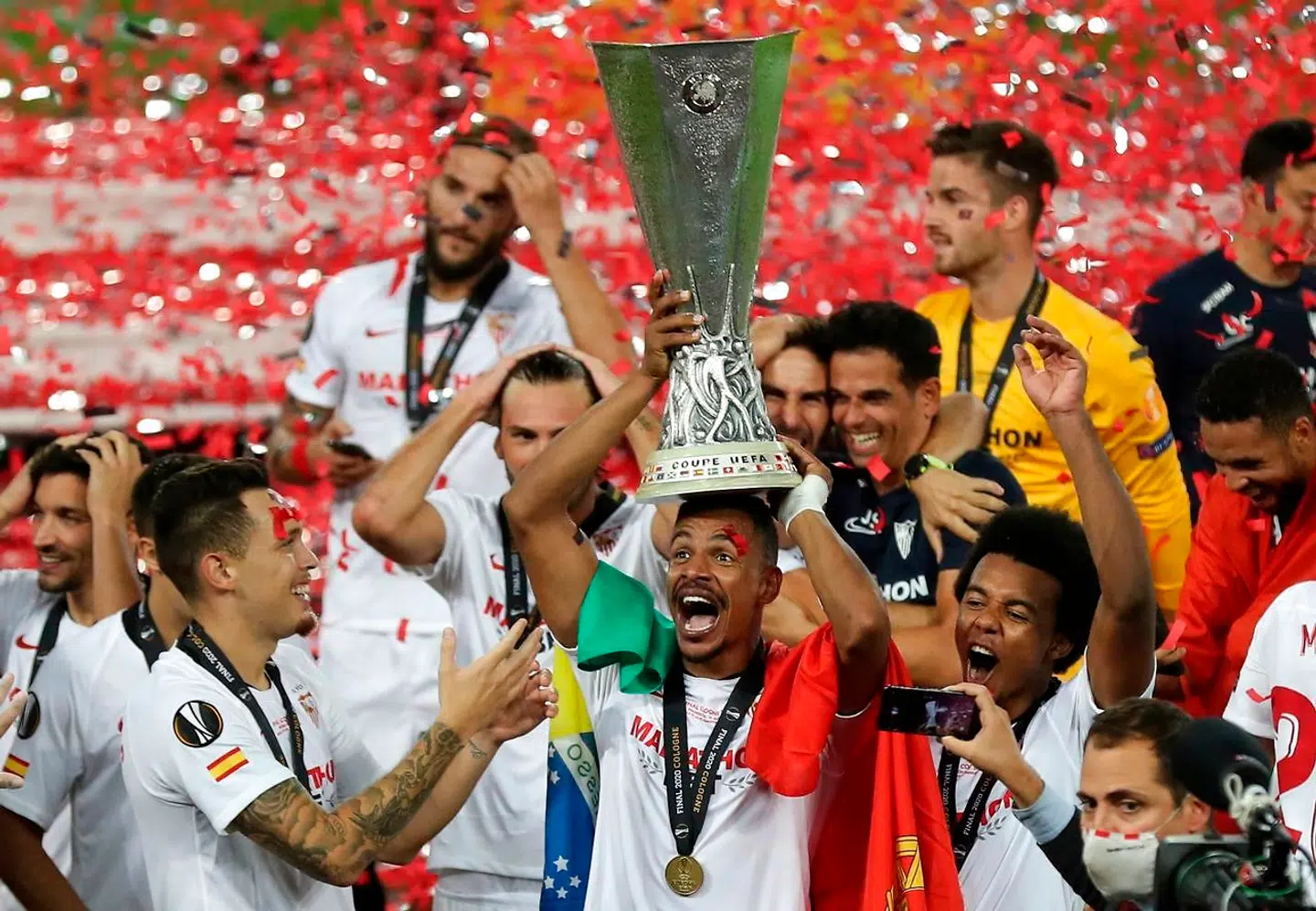 Sevilla's Brazilian midfielder Fernando celebrates with trophy after the UEFA Europa League final football match Sevilla v Inter Milan on August 21, 2020 in Cologne, western Germany. (Photo by Friedemann Vogel / POOL / AFP)