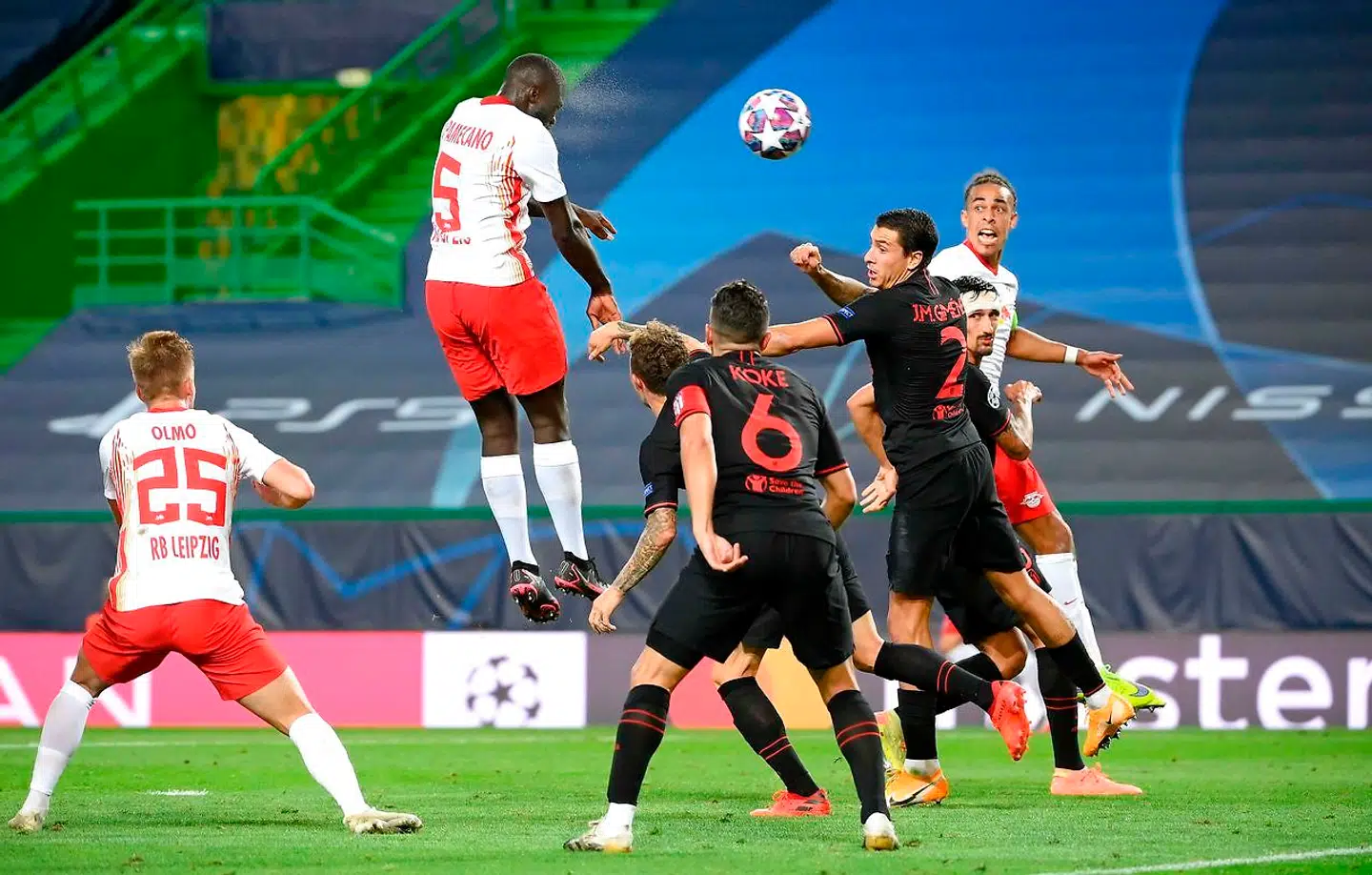 Leipzig's French defender Dayot Upamecano (TOP) heads the ball during the UEFA Champions League quarter-final football match between Leipzig and Atletico Madrid at the Jose Alvalade stadium in Lisbon on August 13, 2020. (Photo by LLUIS GENE / POOL / AFP)