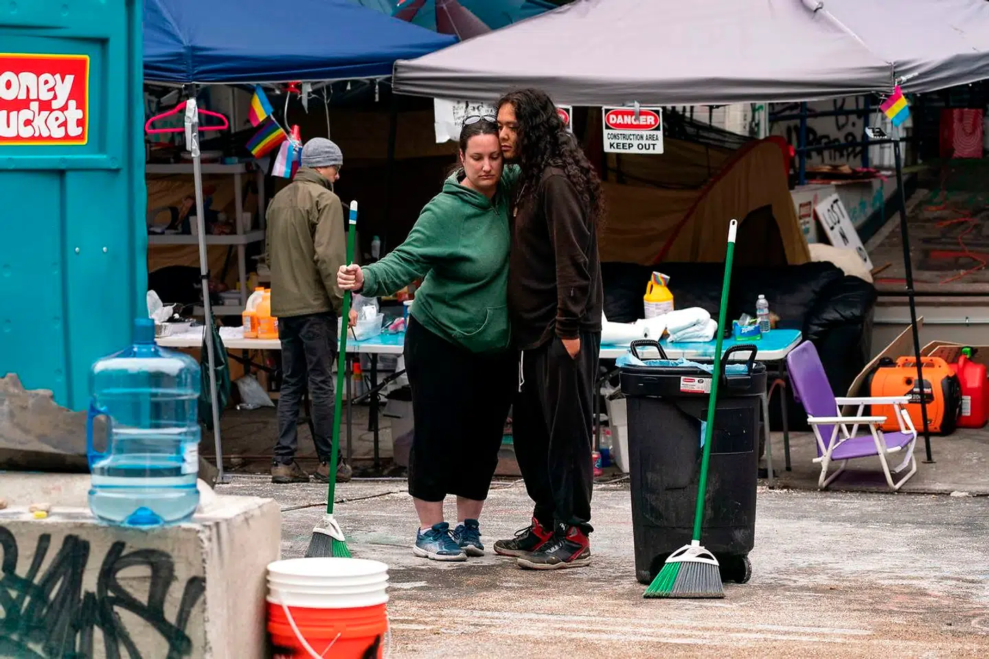 En kvinde giver en mand er knus, efter en ung mand blev dræbt under et skyderi i Seattle.