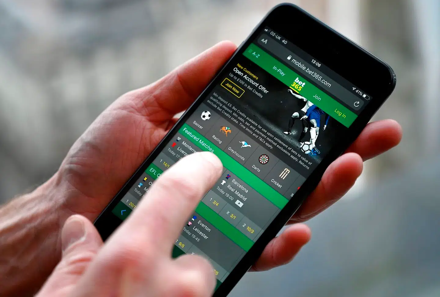 A man poses for a photograph with the online gambling website Bet365 displayed on a smartphone, in London on December 18, 2019. Denise Coates, chief executive of British online betting giant Bet365, has retained her place as Britain's highest-paid boss, according to the group's annual report published on Wednesday. She was paid a basic salary of £277 million ($366 million, 328 million euros) in the group's financial year to March, the company's annual report showed. PAUL ELLIS / AFP