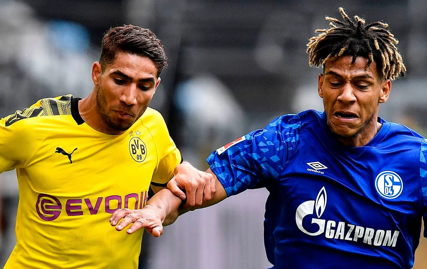 Dortmund's Moroccan defender Achraf Hakimi (L) vies with Schalke's French defender Jean-Clair Todibo during the German first division Bundesliga football match BVB Borussia Dortmund v Schalke 04 on May 16, 2020 in Dortmund, western Germany as the season resumed following a two-month absence due to the novel coronavirus COVID-19 pandemic. (Photo by Martin Meissner / POOL / AFP) / DFL REGULATIONS PROHIBIT ANY USE OF PHOTOGRAPHS AS IMAGE SEQUENCES AND/OR QUASI-VIDEO