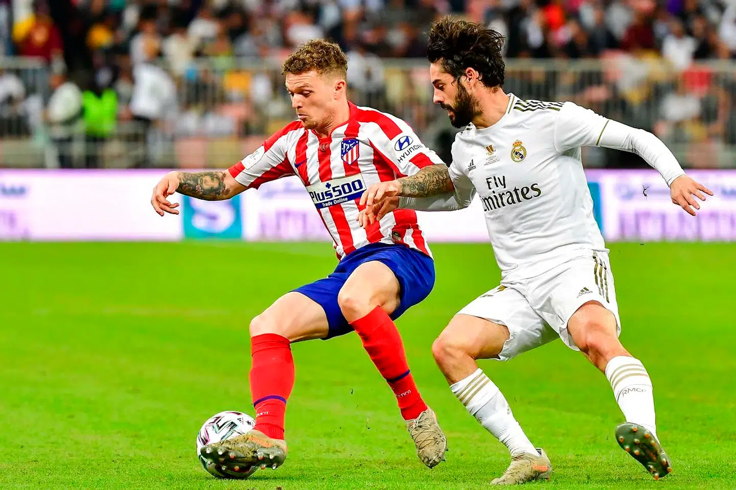 Atletico Madrid's English defender Kieran Trippier (L) is marked by Real Madrid's Spanish midfielder Isco during the Spanish Super Cup final between Real Madrid and Atletico Madrid on January 12, 2020, at the King Abdullah Sports City in the Saudi Arabian port city of Jeddah. (Photo by Giuseppe CACACE / AFP)