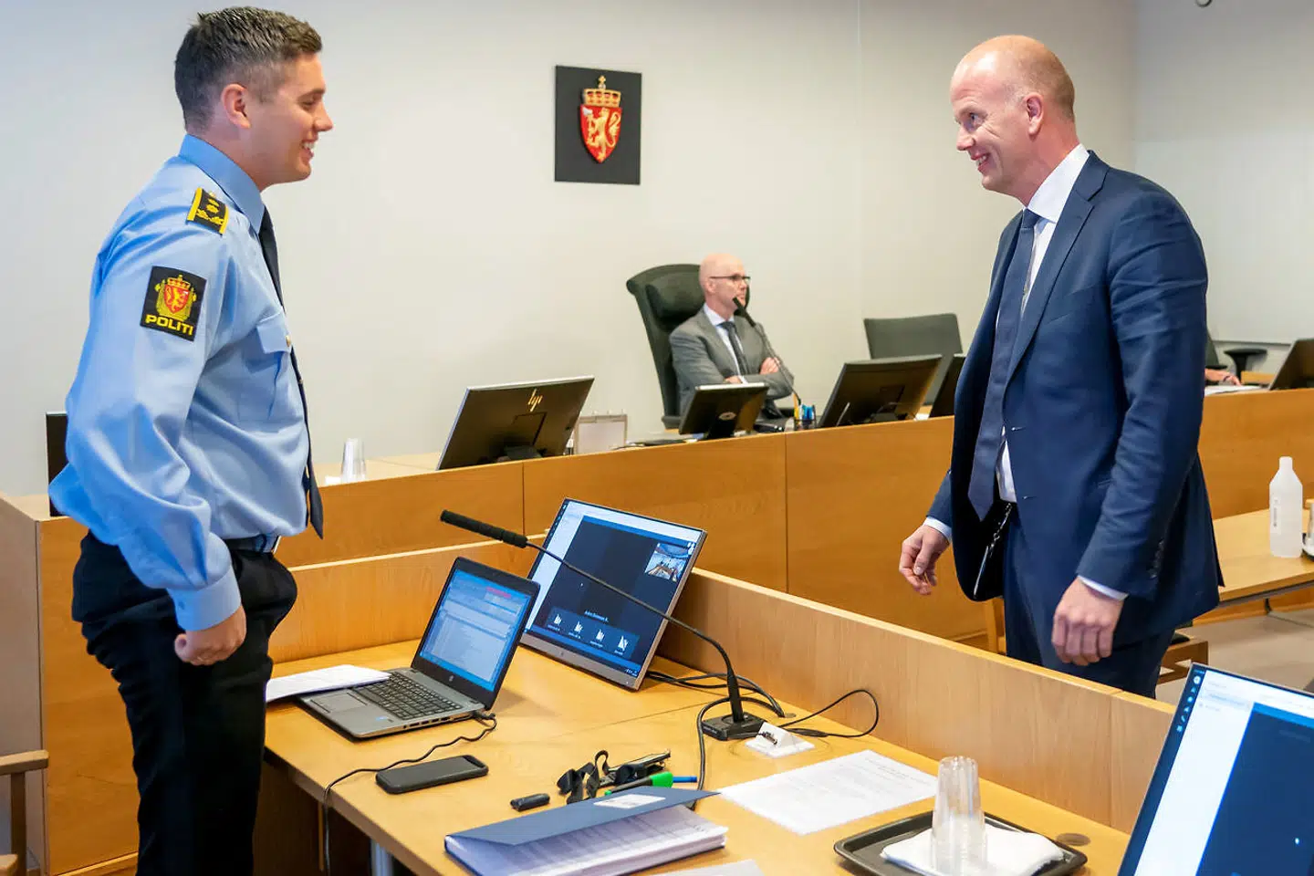 Tom Hagen's lawyer Svein Holden and police officer Mathias Hager speak in the courtroom right before Tom Hagen is being held for detention in Lillestrom, Norway, April 29, 2020. Heiko Junge/NTB scanpix via REUTERS ATTENTION EDITORS - THIS IMAGE WAS PROVIDED BY A THIRD PARTY. NORWAY OUT.NO COMMERCIAL OR EDITORIAL SALES IN NORWAY.