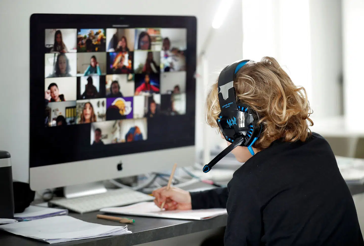 A student takes online classes at home, with his companions, using the Zoom APP during the coronavirus disease (COVID-19) outbreak in El Masnou, north of Barcelona, Spain April 2, 2020. REUTERS/Albert Gea