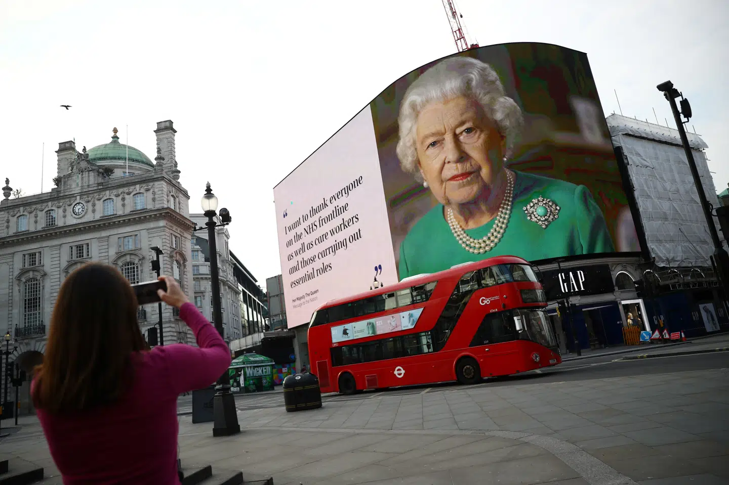 Her ses dronning Elizabeth II på en storskærm på Piccadilly Circus midt i London 8. april. Den 93-årige dronning er to gange gået ud med budskaber om sammenhold til briterne i løbet af coronakrisen. Hannah Mckay/Reuters