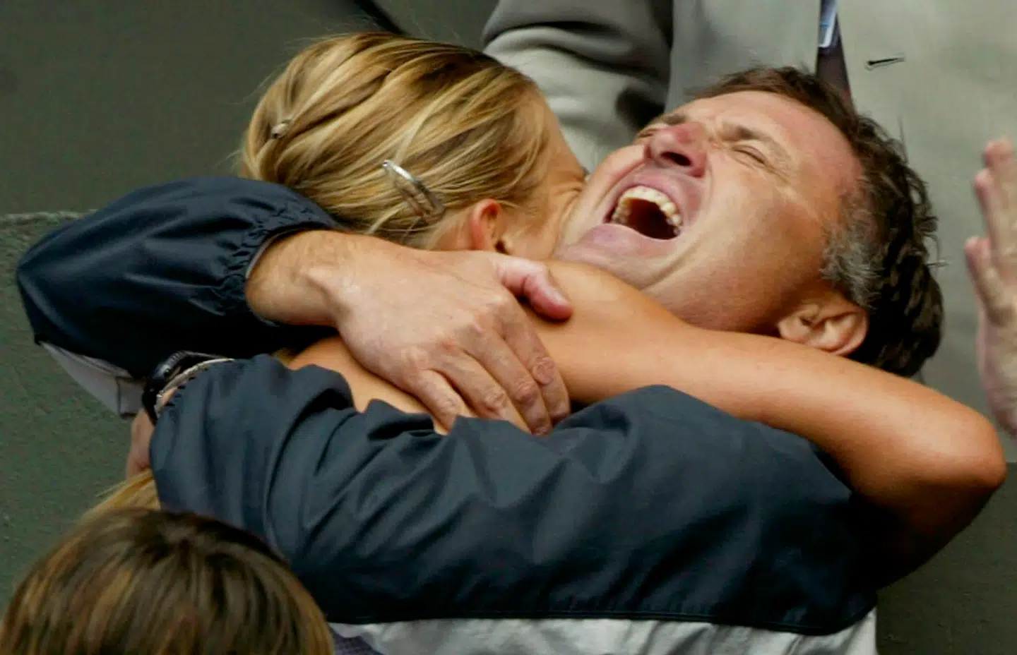Thirteenth seed Maria Sharapova of Russia (L) embraces her father Yuri (R) after defeating top seed Serena Williams of the U.S. in their women's singles final match on Centre Court at the Wimbledon Tennis Championships in London, July 3, 2004. Seventeen-year-old Sharapova won the match, which was her first Wimbledon and Grand Slam singles title, 6-1 6-4. REUTERS/Ian Hodgson
