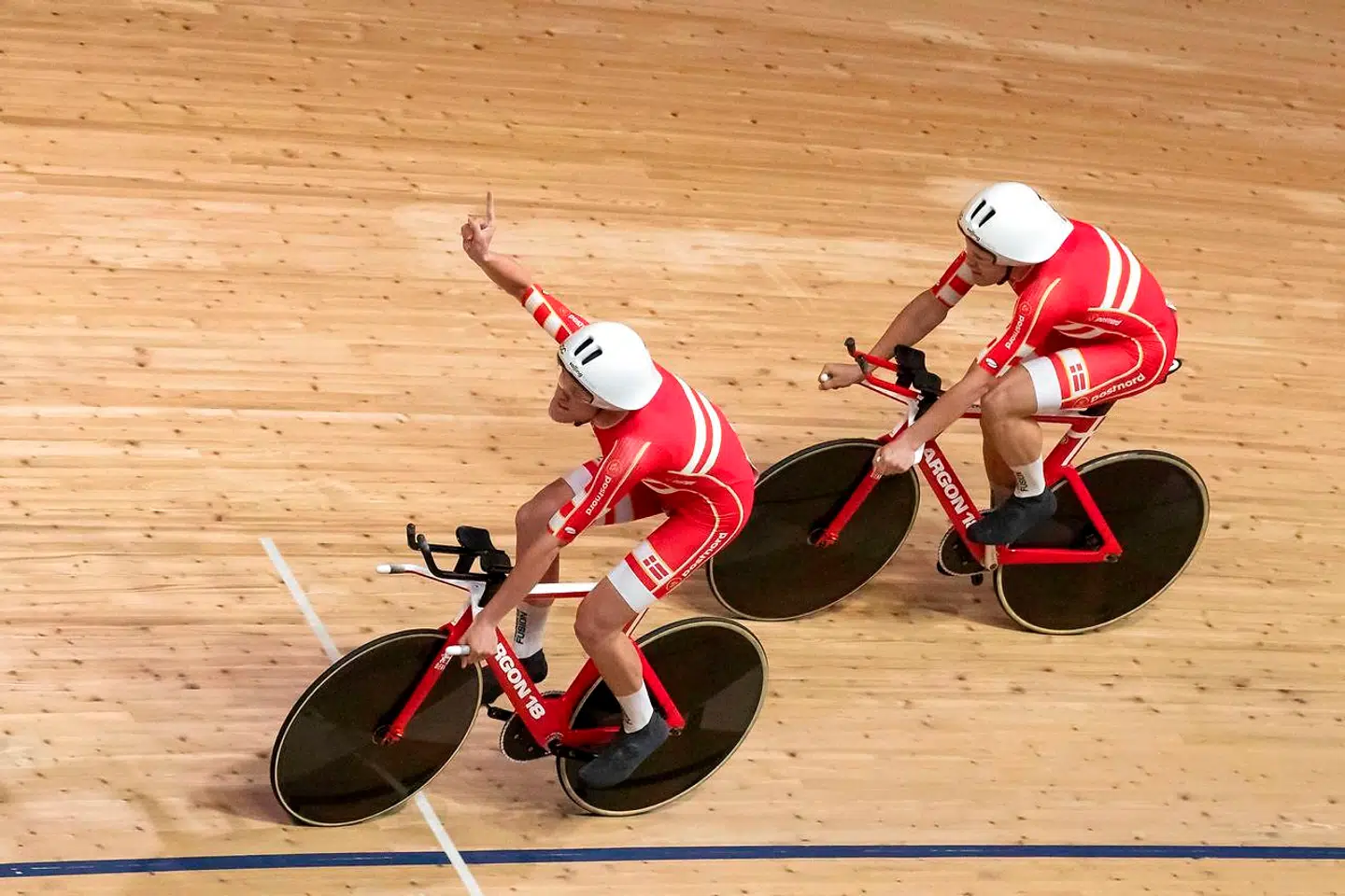 Members of Denmark's team celebrate after they set a new world record compete in the Men's Team Pursuit qualifying at the UCI track cycling World Championship in Berlin on February 26, 2020. (Photo by Odd ANDERSEN / AFP)