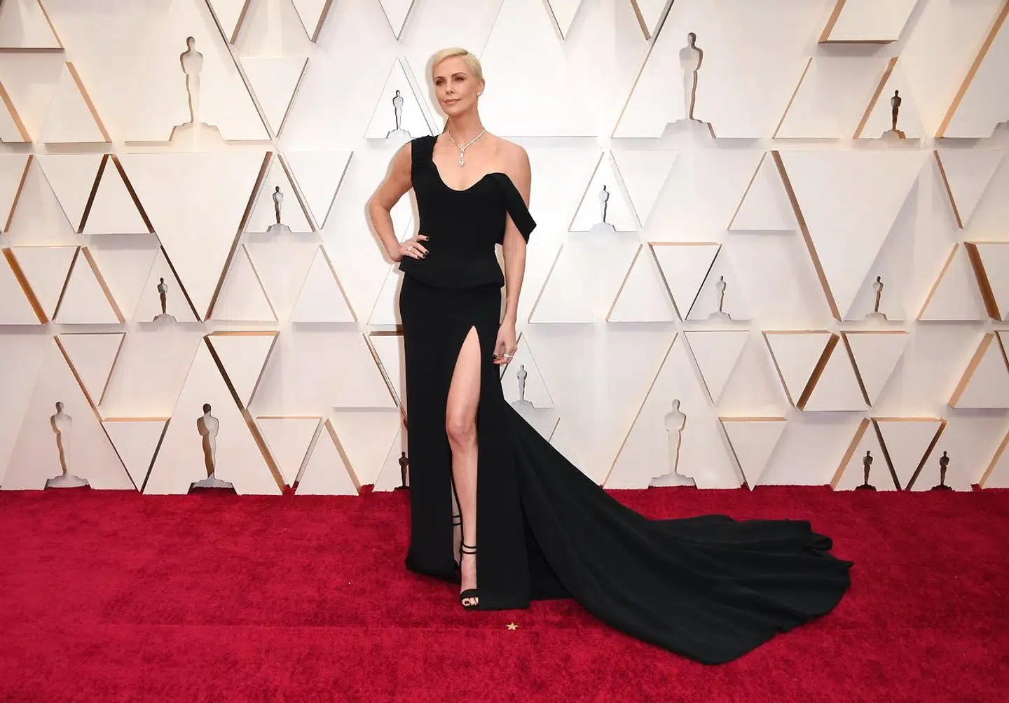 Charlize Theron i en sort kjole med langt slæb.