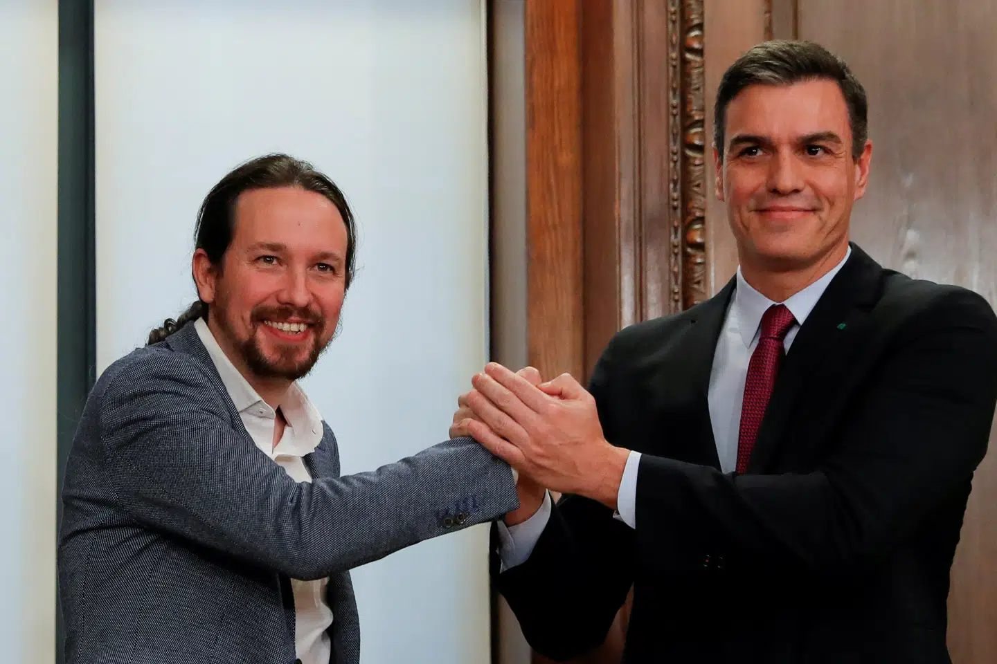 Spaniens fungerende premierminister, Pedro Sanchez (t.h.), og Unidas Podemos' partileder, Pablo Iglesias, underskrev kort inden nytår en regeringsaftale. Nu skal den igennem en tillidsafstemning i parlamentet, inden de to partier kan indtage regeringskontorerne. Susana Vera/Reuters