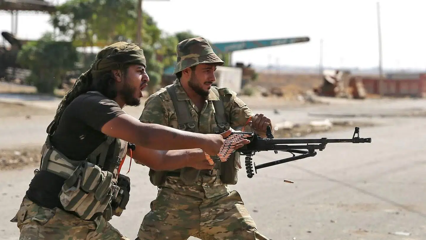 Turkish-backed Syrian fighters take part in a battle in Syria's northeastern town of Ras al-Ain in the Hasakeh province along the Turkish border as Turkey and its allies continue their assault on Kurdish-held border towns in northeastern Syria. - Ras al-Ain, is the main remaining flashpoint along the border where Kurdish-led SDF have been putting up stiff resistance against Turkish air strikes and shelling for almost a week. (Photo by Nazeer Al-khatib / AFP)