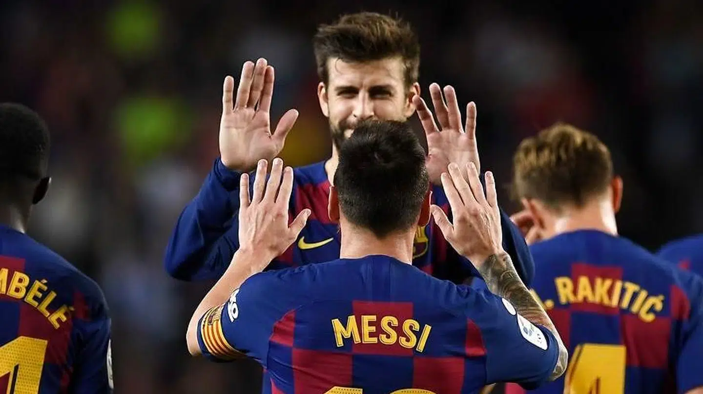 TOPSHOT - Barcelona's Argentine forward Lionel Messi celebrates his goal with Barcelona's Spanish defender Gerard Pique during the Spanish league football match between FC Barcelona and Sevilla FC at the Camp Nou stadium in Barcelona on October 6, 2019. (Photo by Josep LAGO / AFP)