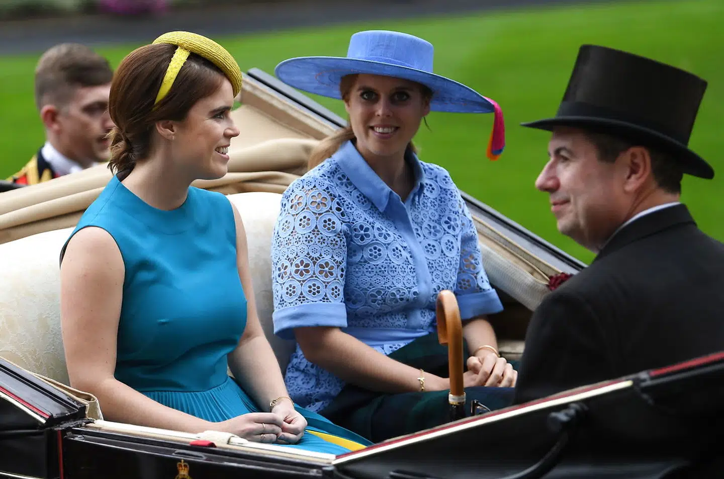 epa07655877 Britain's Princess Eugenie of York (L) and Princess Beatrice of York (C) arrive in the parade ring at Royal Ascot, in Ascot, Britain 18 June 2019. Royal Ascot is Britain's most valuable horse race meeting and social event running from 18 to 22 June 2019. EPA/NEIL HALL