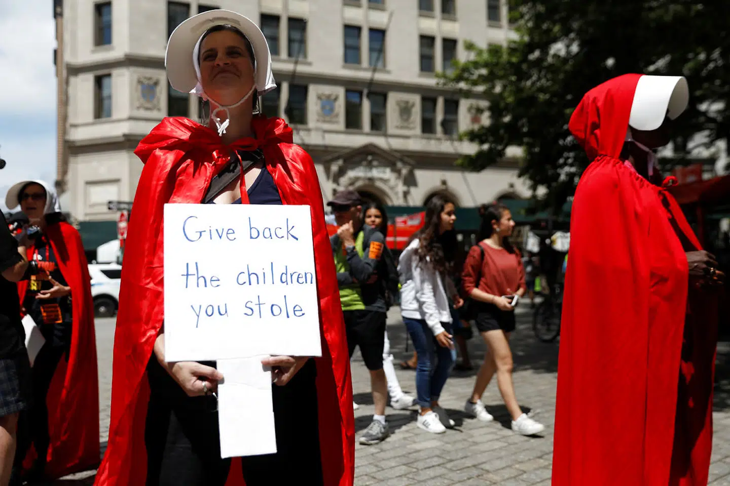 Women dressed in red gowns as worn in the "Handmaids Tale" protest U.S. Vice President Mike Pence and Department of Homeland Security (DHS) Secretary Kirstjen Nielsen outside the DHS Cybersecurity Summit in Manhattan, New York, U.S., July 31, 2018. REUTERS/Shannon Stapleton