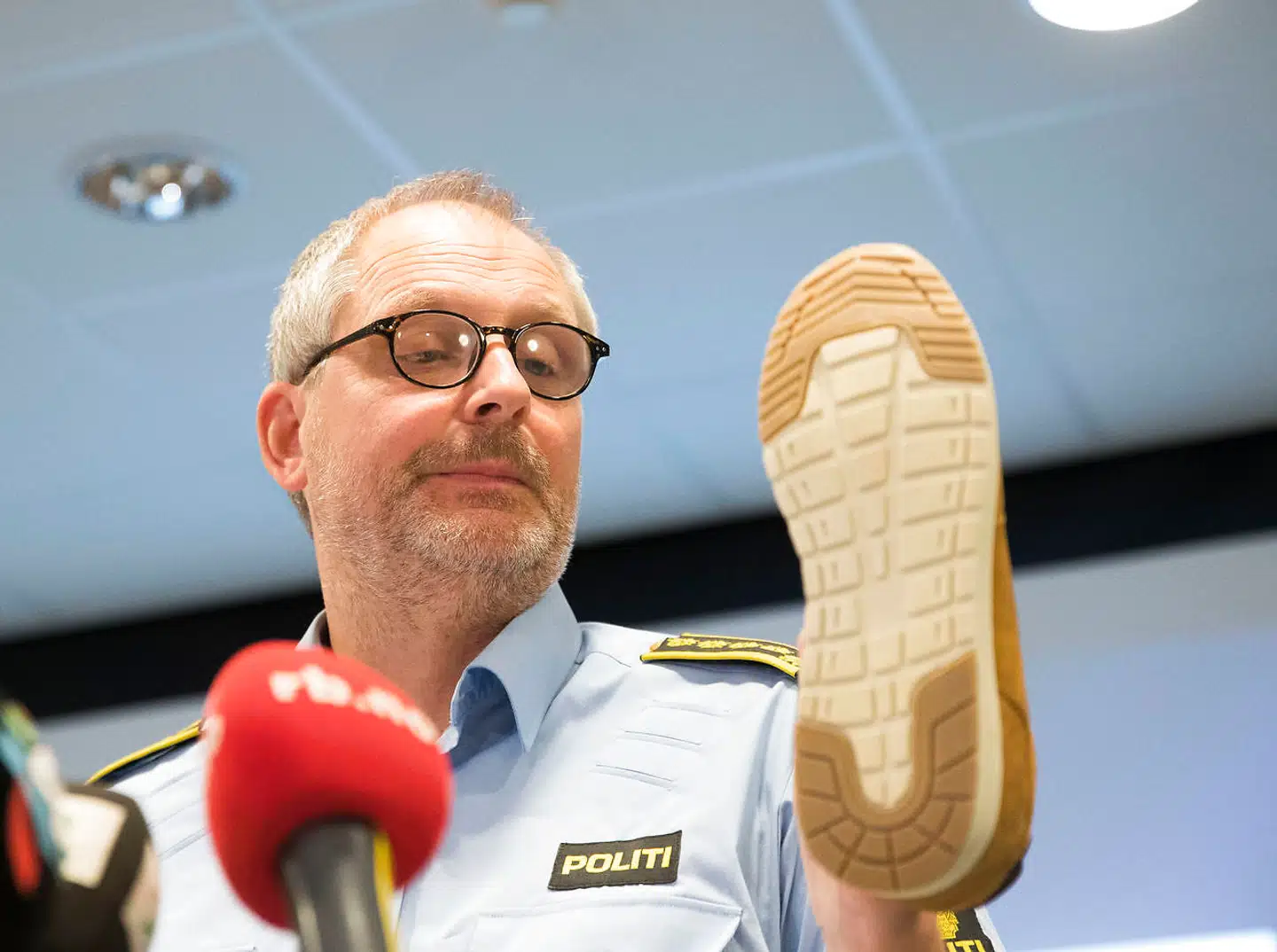 Efterforskningsleder Tommy Brøske fremviser en kondisko med samme sål som det aftryk, der blev fundet.