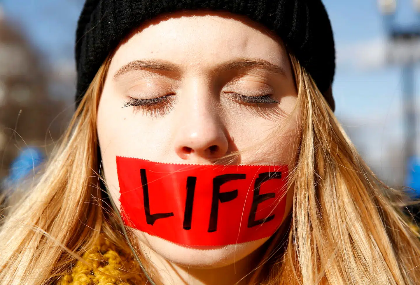 A protester with her mouth taped over with the word "life" stands in front of the U.S. Supreme Court on the morning the court takes up a major abortion case focusing on whether a Texas law that imposes strict regulations on abortion doctors and clinic buildings interferes with the constitutional right of a woman to end her pregnancy, in Washington March 2, 2016. REUTERS/Kevin Lamarque TPX IMAGES OF THE DAY
