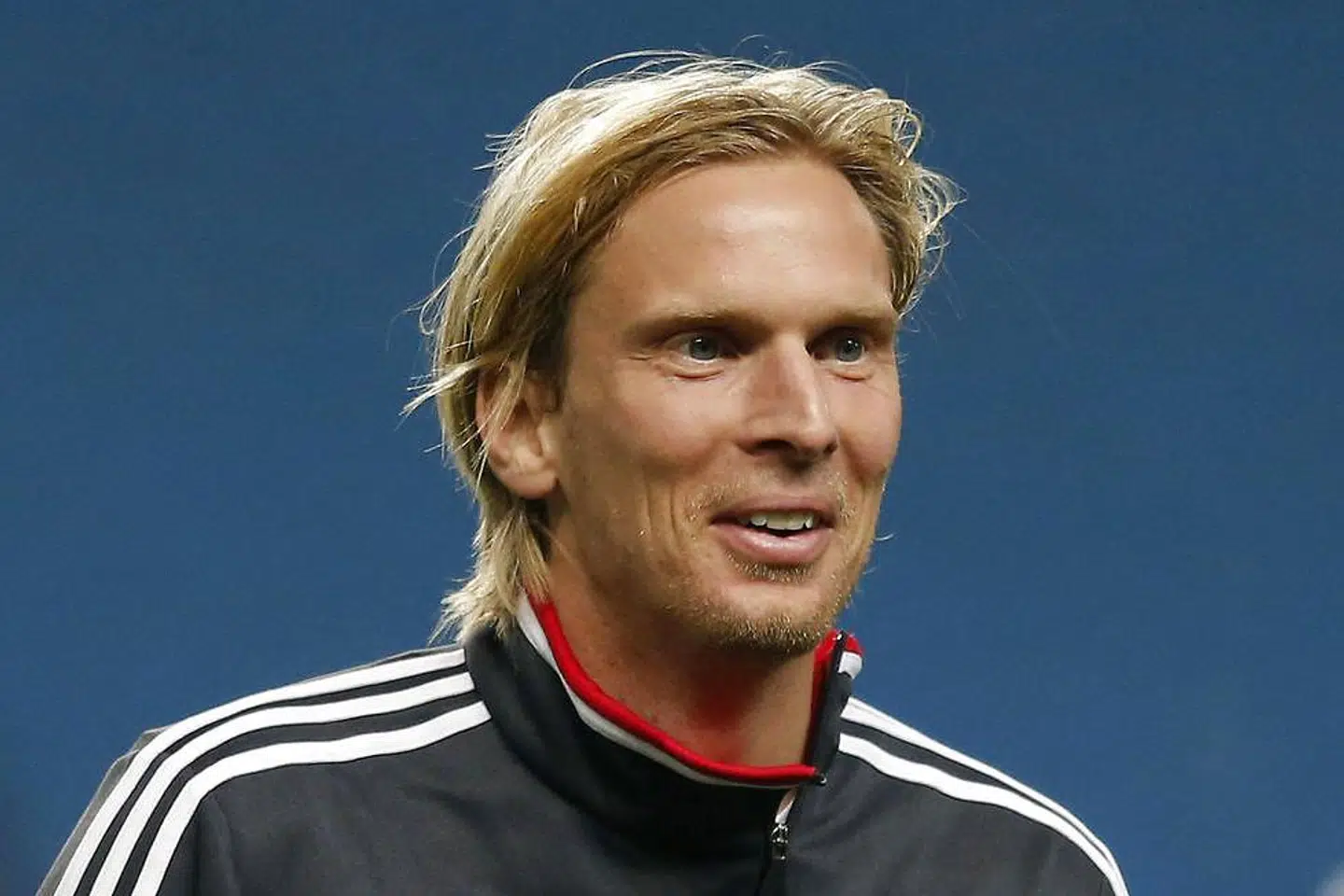 Ajax's Christian Poulsen smiles during a training session at Manchester City's Etihad Stadium in Manchester, northern England, November 5, 2012. Ajax are set to play Manchester City in the Champions League on Tuesday. REUTERS/Phil Noble (BRITAIN - Tags: SPORT SOCCER)