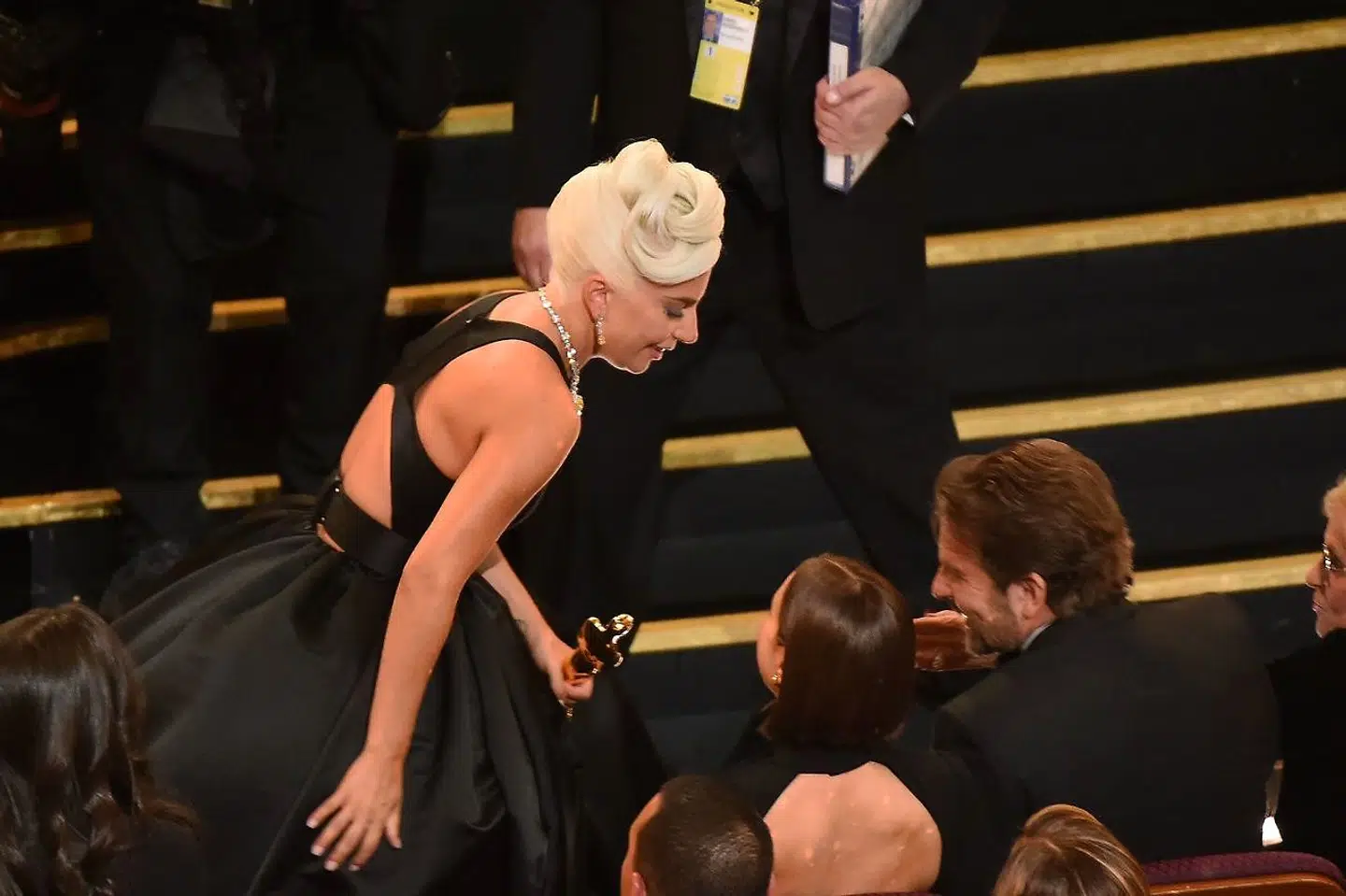 Actress and Singer Lady Gaga talks with Irina Shayk (C) and Bradley Cooper during the 91st Annual Academy Awards at the Dolby Theatre in Hollywood, California on February 24, 2019. (Photo by VALERIE MACON / AFP)