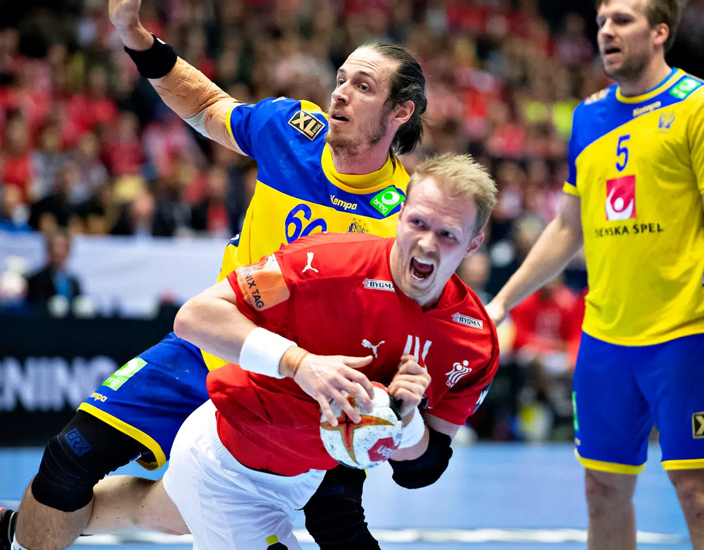 Anders Zachariassen of Denmark is stopped by Kim Ekdahl du Rietz of Sweden during the men's IHF Handball World Championship Main Round Group 2 match between Denmark and Sweden in Herning, Denmark, Wednesday, Jan. 23, 2019.