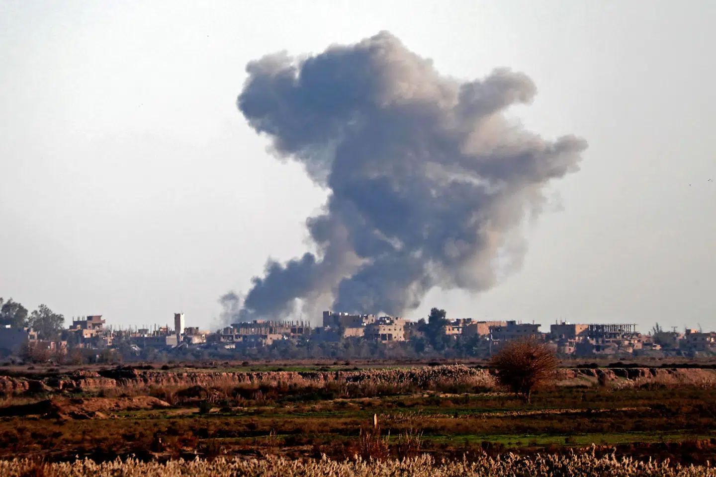 TOPSHOT - Smoke billows after bombings in the Deir Ezzor province, near Hajin, eastern Syria, on December 15, 2018. - Kurdish-led forces seized the Islamic State's main hub of Hajin on December 14, a milestone in a massive and costly US-backed operation to eradicate the jihadists from eastern Syria. The Syrian Democratic Forces secured Hajin, the largest settlement in what is the last pocket of territory controlled by IS, the Syrian Observatory for Human Rights said. (Photo by Delil SOULEIMAN / AFP)
