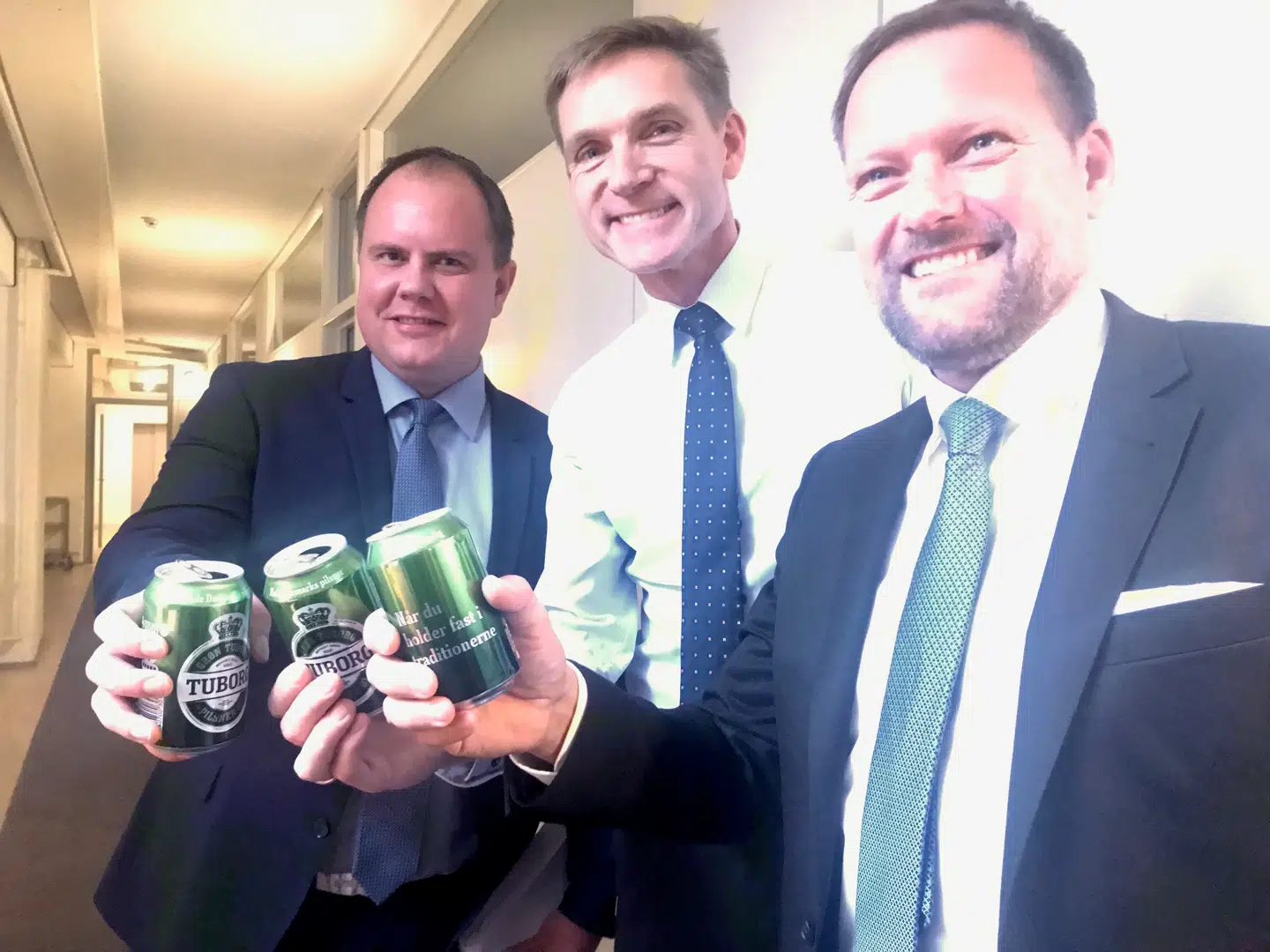 Martin Henriksen, Kristian Thulesen Dahl og René Christensen skåler på resultatet. Foto: Andreas Karker