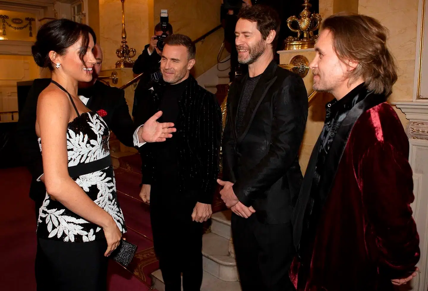 Meghan (L), Duchess of Sussex, meets members of British band Take That, Gary Barlow (3R), Howard Donald (2R) and Mark Owen as she attends the annual Royal Variety Performance at the Palladium Theatre in central London on November 19, 2018. (Photo by Ian Vogler / various sources / AFP)