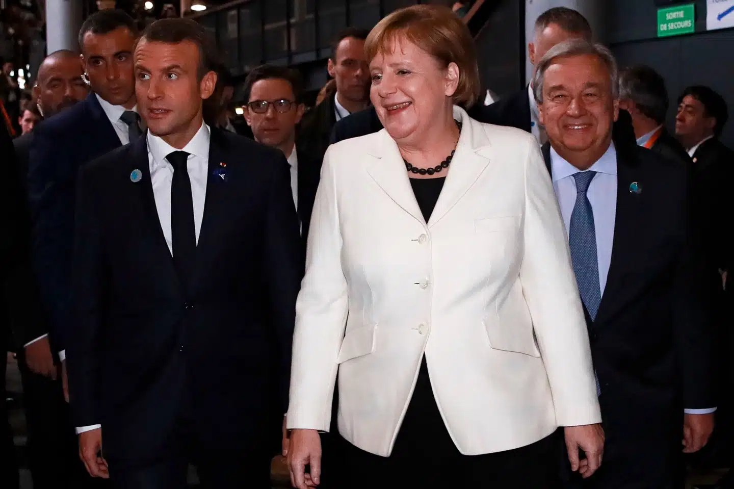 Frankrigs præsident, Emmanuel Macron (t.v.), ankommer sammen med Tysklands forbundskansler, Angela Merkel (i midten), og FN's generalsekretær, António Guterres (t.h.), til fredskonferencen i Paris søndag. Gonzalo Fuentes/Ritzau Scanpix