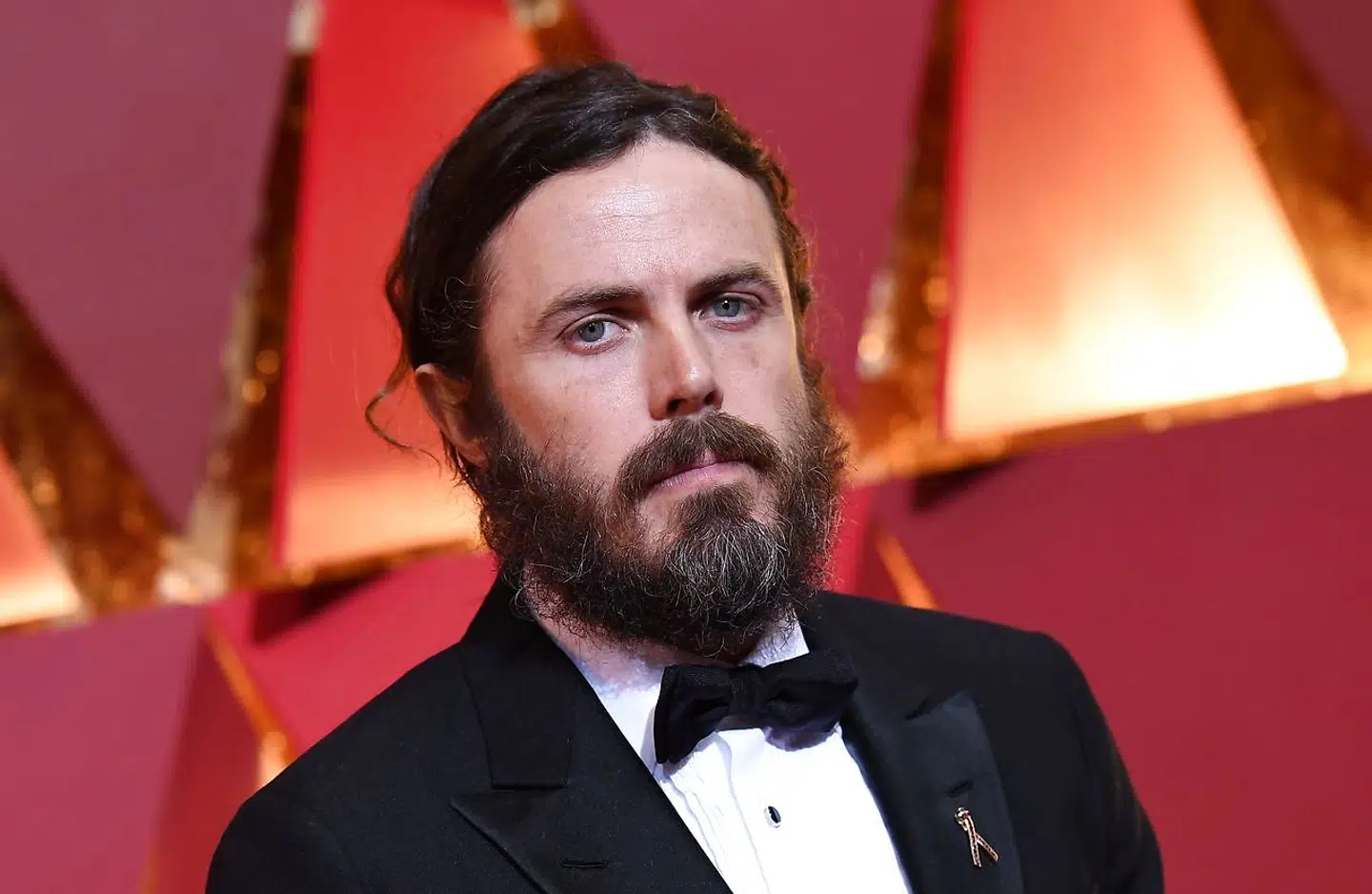 (FILES): This file photo taken on February 26, 2017 shows nominee for best actor in "Manchester By The Sea" Casey Affleck as he arrives on the red carpet for the 89th Oscars in Hollywood, California. Scandal-hit Casey Affleck has withdrawn from presenting the best actress award at the Oscars, the Academy of Motion Picture Arts and Sciences and the actor's publicist told AFP on January 25, 2018. Neither gave a reason for Affleck pulling out of the March 4 ceremony, but the announcement comes after renewed attention on historic accusations of sexual harassment against the 42-year-old star. / AFP PHOTO / ANGELA WEISS