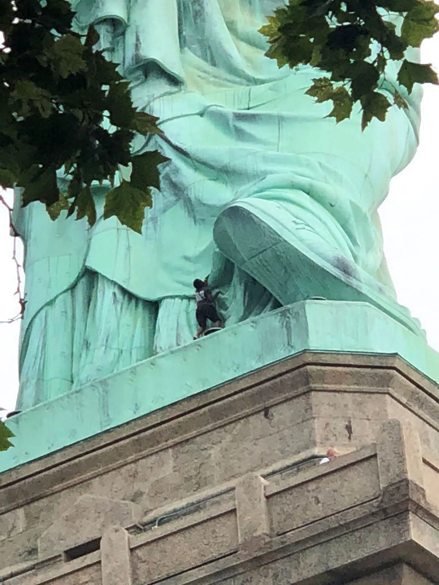 A protester is seen on the Statue of Liberty in New York, New York, U.S., July 4, 2018 in this picture obtained from social media. Danny Owens/via REUTERS THIS IMAGE HAS BEEN SUPPLIED BY A THIRD PARTY. MANDATORY CREDIT.NO RESALES.NO ARCHIVES