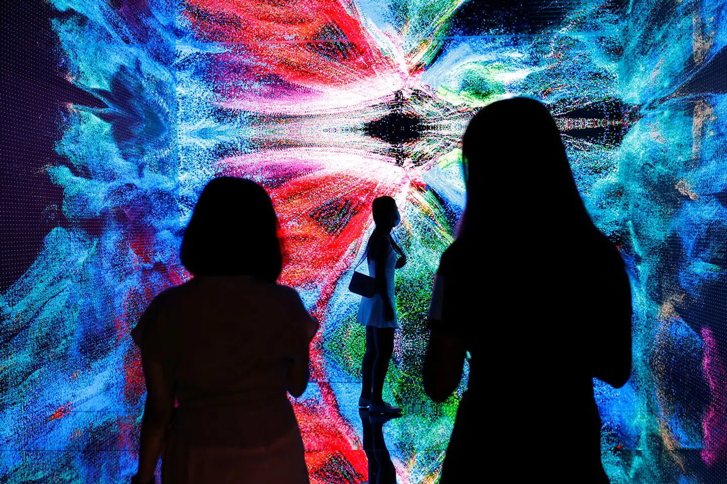 Visitors are pictured in front of an immersive art installation titled "Machine Hallucinations - Space: Metaverse" by media artist Refik Anadol, which will be converted into NFT and auctioned online at Sotheby's, at the Digital Art Fair, in Hong Kong, China September 30, 2021. REUTERS/Tyrone Siu TPX IMAGES OF THE DAY