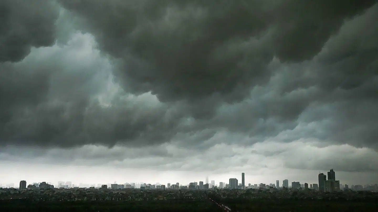TOPSHOT - Dark clouds hover over the skyline in Hanoi on April 1, 2019. (Photo by Manan VATSYAYANA / AFP)
