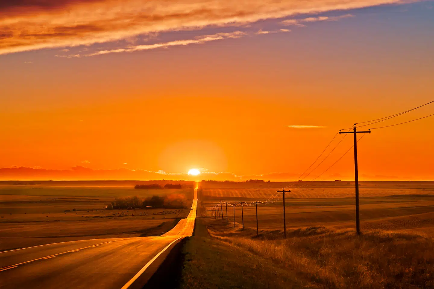 Sunset at the September equinox, in this case on September 22, 2021, which was the evening of the day of equinox this year, which occurred on the afternoon of Sept. 22. Thus the Sun is settting very close to due west, marked by the direction of the prairie highway. After the date of the September equinox the Sun sets farther to the south of west, until the December solstice. I shot hiis to illustrate the equinox alignment. This is a 7-exposure blend, from a short 1/3200-second image for essentially just the Sun's disk, to 1/50th second for the sky and foreground. All were with the 24-105mm RF lens at f/11 and 105mm, and the Canon EOS Ra at ISO 100. The images were blended not with HDR but with luminosity masks created with the ADP Pro (aka Lumiflow) extension panel for Photoshop, which does an auto-blend for up to 7 images. I added a mild Orton glow effect with Luminar AI. Dodge and burn touchups added with TKActions v8. I shot this same scene from the same location the evening before, thinking this night would be too cloudy. But clouds cleared off just in time to shoot the sunset.