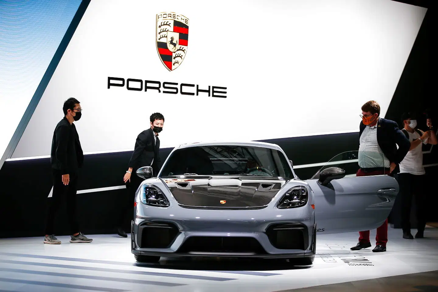 Attendees look at the 2022 Porsche 718 Cayman GT4 RS during the 2021 LA Auto Show in Los Angeles, California, U.S. November 17, 2021. REUTERS/Ringo Chiu