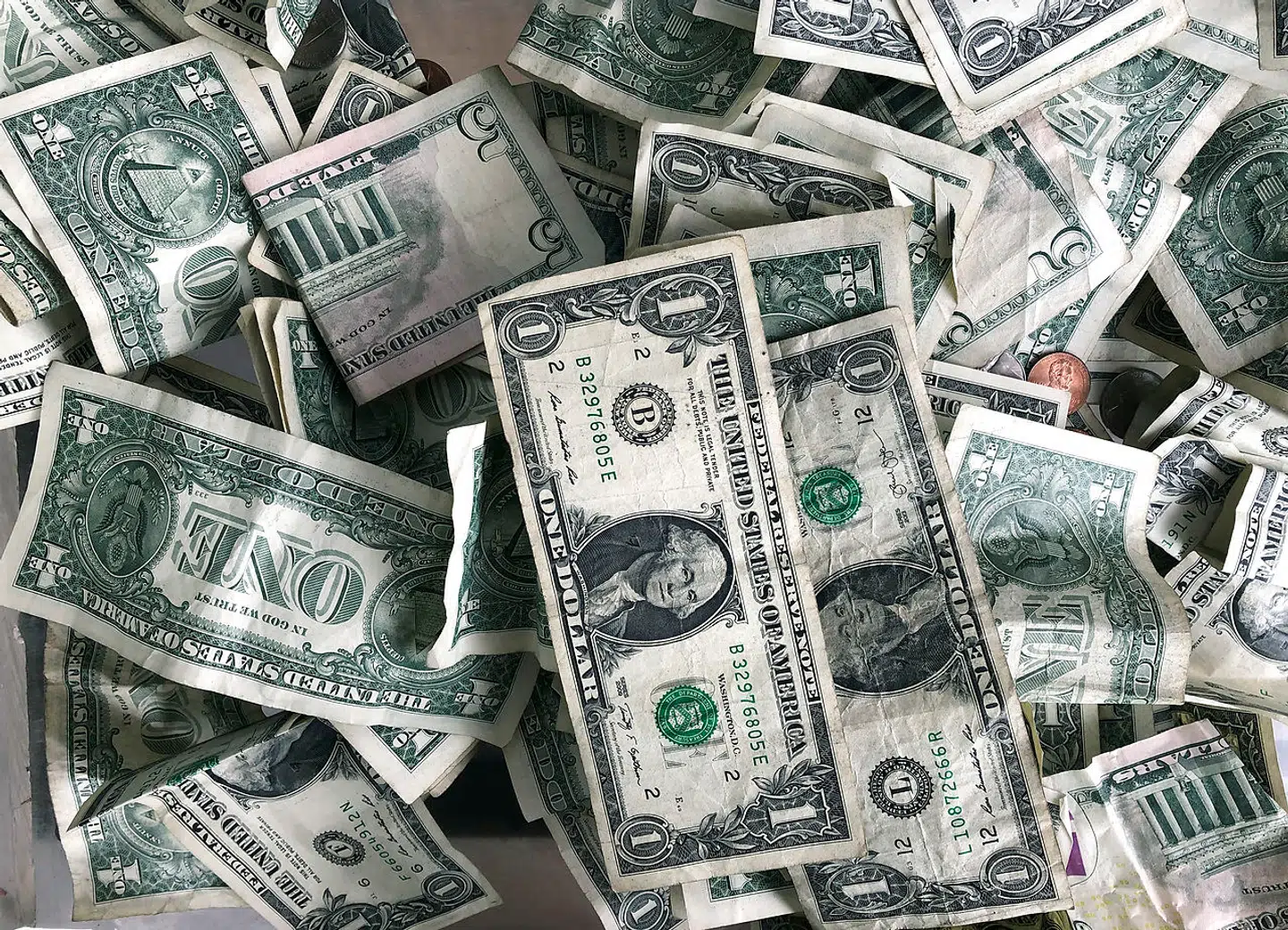Dollar bills are deposited in a tip box, Sept. 9, 2020 in New York. (AP Photo/Mark Lennihan)