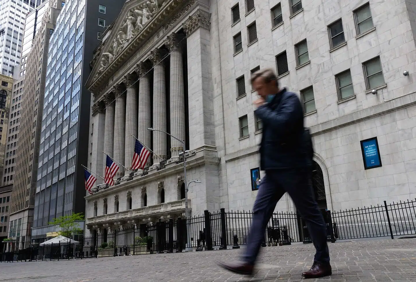 (FILES) In this file photo taken on May 10, 2021 A man walks past the New York Stock Exchange on Wall Street in New York City. - There is still a ways to go, but Robert Byrnes has been heartened by signs that more New Yorkers are getting back to the office after the coronavirus pandemic. "The subway train was absolutely packed this morning, " he said. "I'm back to waiting in lines at lunchtime." Still, Byrnes, who heads the East Midtown Partnership, a trade group whose offices are near Grand Central Station, estimated that only about one third of the neighborhood's workforce has come back to their cubicles. "Quick meal-type restaurants are still suffering a severe financial impact, " he said. "It's slowly getting better." Other benchmarks corroborate Byrnes's sense of the lag in New York office employees' return to in-person workdays. In May, 62 percent of large employers surveyed by the Partnership for New York City estimated that their workers would be back in the office by September. (Photo by Angela Weiss / AFP)