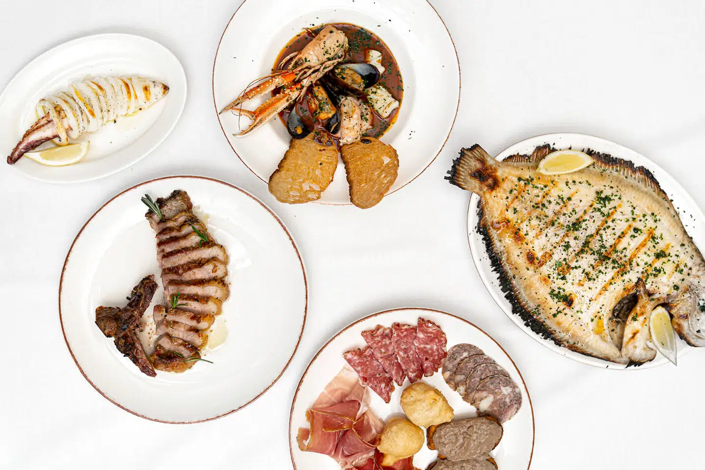 Calamari grigliati, antipasto toscano, cacciucco, grillet slethvar og svinekotelet på Circolo.