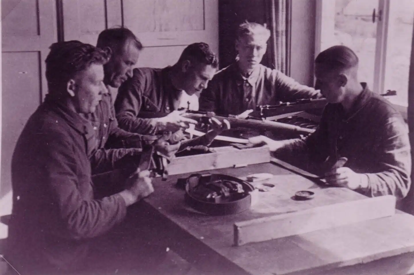 Danske medlemmer af Waffen SS med våben ved et bord på kasernen i Graz, hvor især danske, norske og hollandske frivillige i nazistisk tjeneste holdt til.