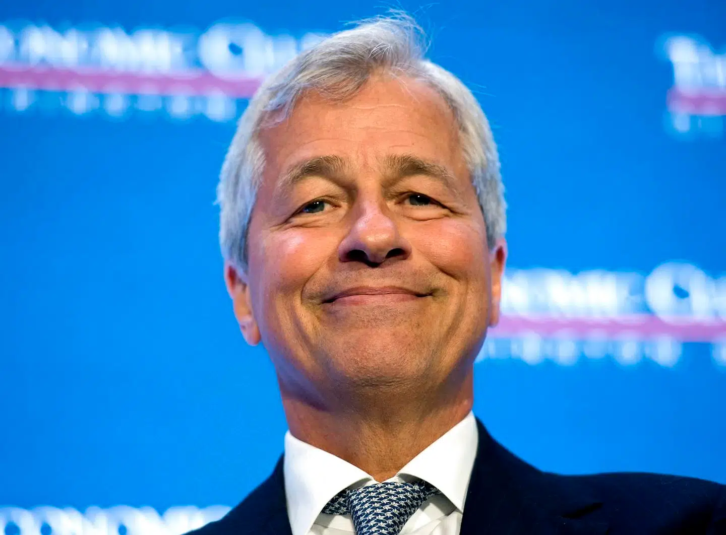 (FILES) This file photo taken on September 12, 2016 shows Jamie Dimon, chairman and CEO of JPMorgan Chase, participates in an interview with David M. Rubenstein, President of the Economic Club of Washington in Washington, DC. JPMorgan Chase said on January 23, 2018 the recent US tax reform and lower regulatory costs allowed it to announce $20 billion in domestic investments over five years, add 4, 000 jobs and raise wages. The biggest US bank by assets, JPMorgan will increase hourly wages by 10 percent on average to between $15 and $18 an hour, depending on market. The change is expected to benefit 22, 000 workers. / AFP PHOTO / MOLLY RILEY