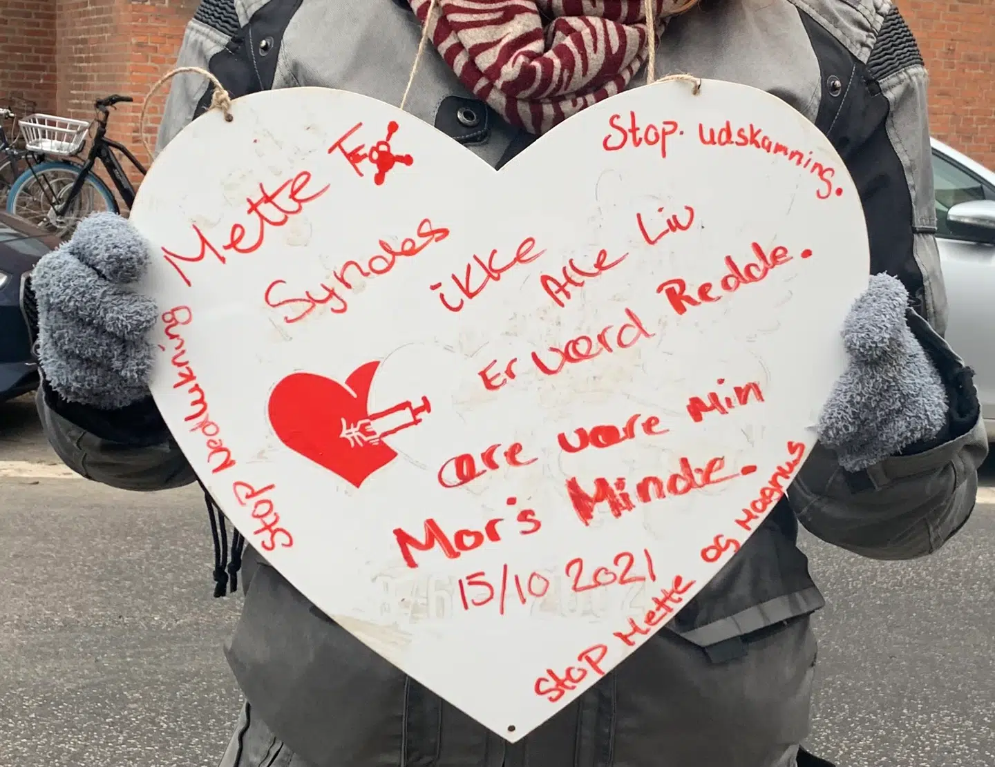 »Mette F synes ikke alle liv er værd at redde. Ære være min mors minde,« står der på Jenni Fiils skilt. Hendes mor døde af kræft i oktober.