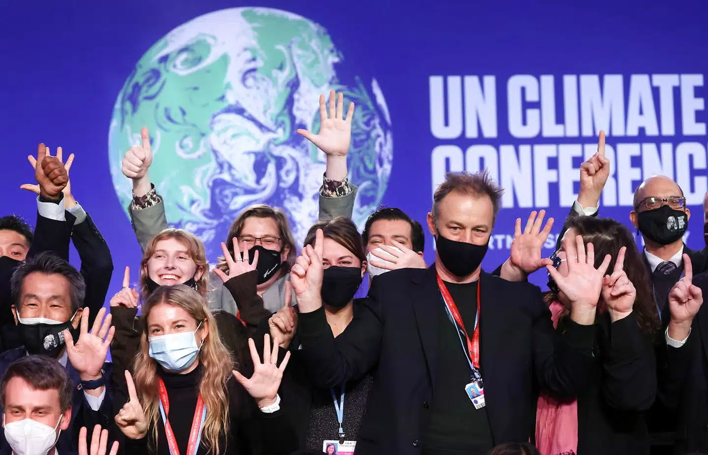 Delegates pose for a picture during the UN Climate Change Conference (COP26) in Glasgow, Scotland, Britain November 13, 2021. REUTERS/Yves Herman
