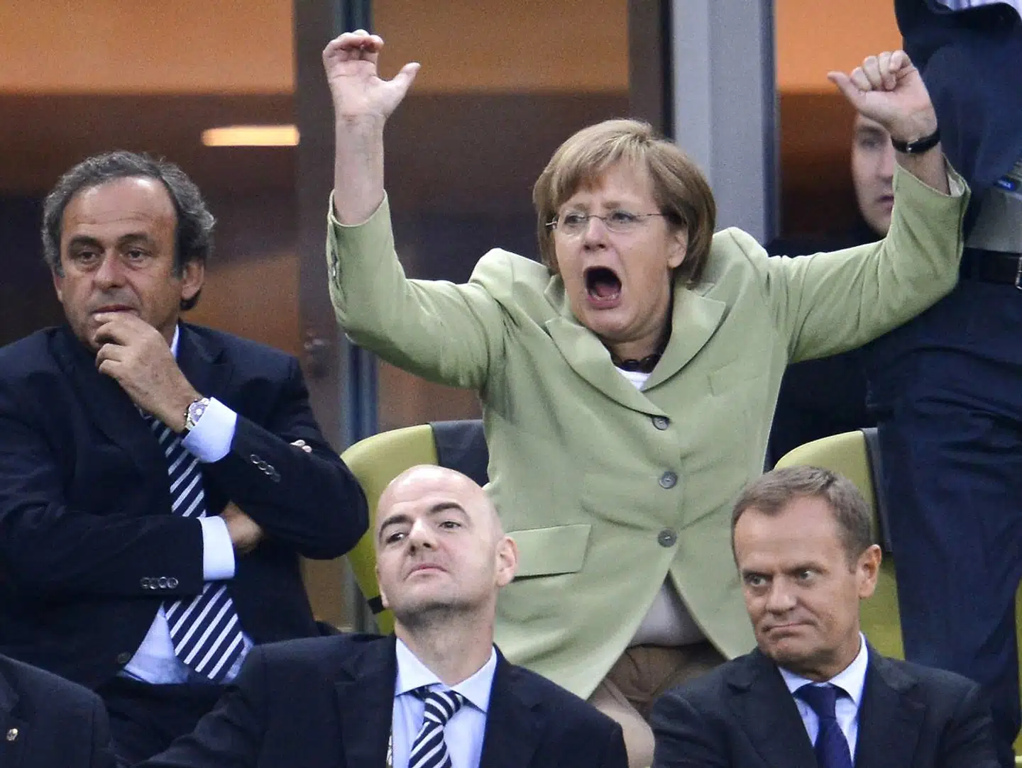 Nogle af de få gange, at Angela Merkel har givet følelserne frit løb offentligt efter at være blevet kansler, er under Tysklands kampe i fodboldslutrunder, som her i Polen i 2012.