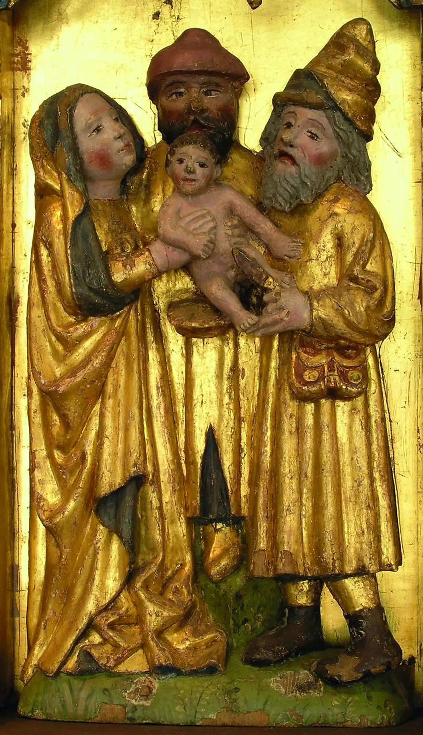 I Boeslunde Kirke er omskærelsen af Jesus gengivet i et træskærerarbejde fra omkring 1430. Omkring Jesus ses Maria til venstre og to mænd. Men hvem er de? Knud Torm foreslår, at manden til højre, der fører kniven, er Josef. Scenen er i øvrigt præget af ro. Illustration fra bogen.