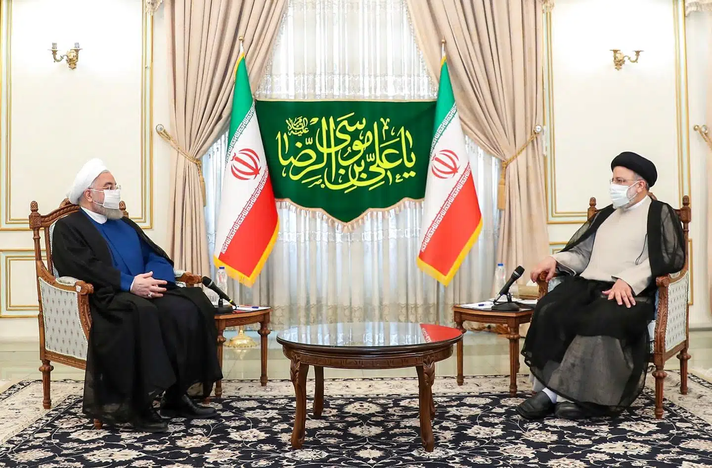A handout picture provided by the Iranian presidency on June 19, 2021, shows outgoing President Hassan Rouhani (L) speaking with President-elect Ebrahim Raisi (L) during a visit to congratulate him on winning the presidential election. - Ultraconservative cleric Ebrahim Raisi was declared the winner Saturday of Iran's presidential election, a widely anticipated result after many political heavyweights were barred from running. (Photo by STRINGER / Iranian Presidency / AFP) / === RESTRICTED TO EDITORIAL USE - MANDATORY CREDIT "AFP PHOTO / HO / IRANIAN PRESIDENCY" - NO MARKETING NO ADVERTISING CAMPAIGNS - DISTRIBUTED AS A SERVICE TO CLIENTS ===