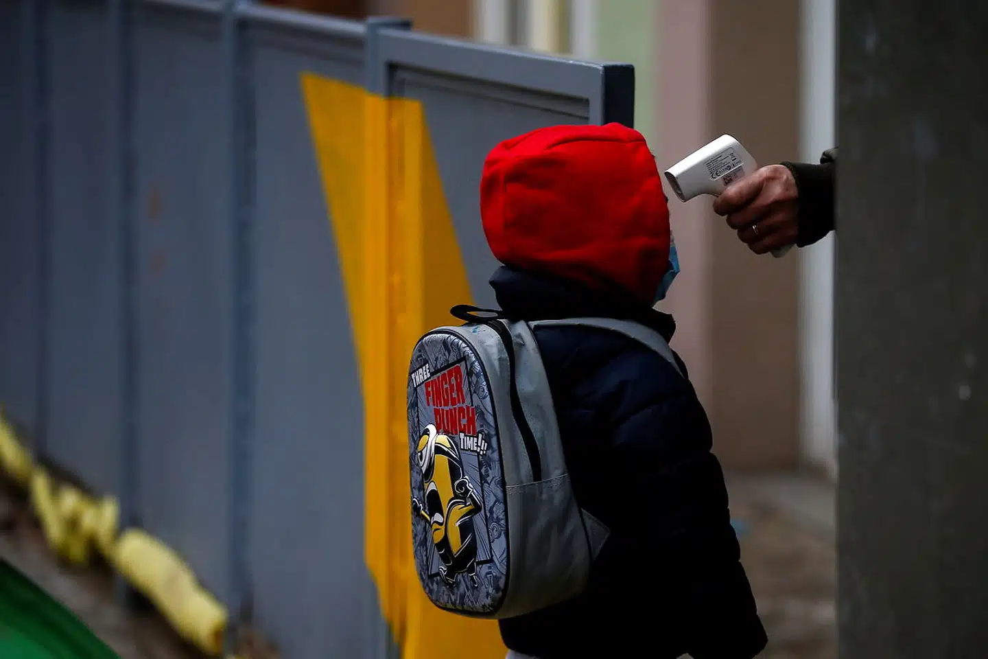 En børnehaveklasseelev bliver tjekket for feber den første dag efter juleferien på en skole i Barcelona. Siden er antallet af smittede elever steget, formentlig på grund af de nye virusvarianter, men uden at der er konstateret større udbrud.