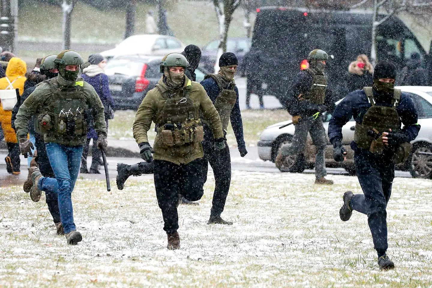 Hviderussisk politi løber efter demonstranter i gaderne i Minsk søndag, hvor oppositionens tilhængere har spredt sig ud over hele byen for at gøre det vanskeligere for politiet at slå ned på dem.